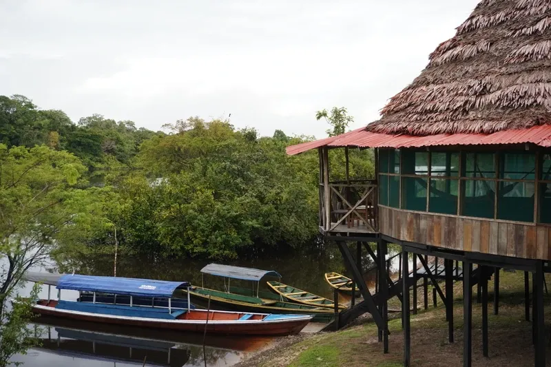 Exterior of Zacambú Eco Lodge surrounded by rainforest and boats | Amazon Jungle Trips