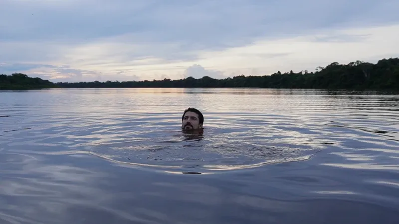 Traveler swimming in Lake Zacambú | Amazon Jungle Trips
